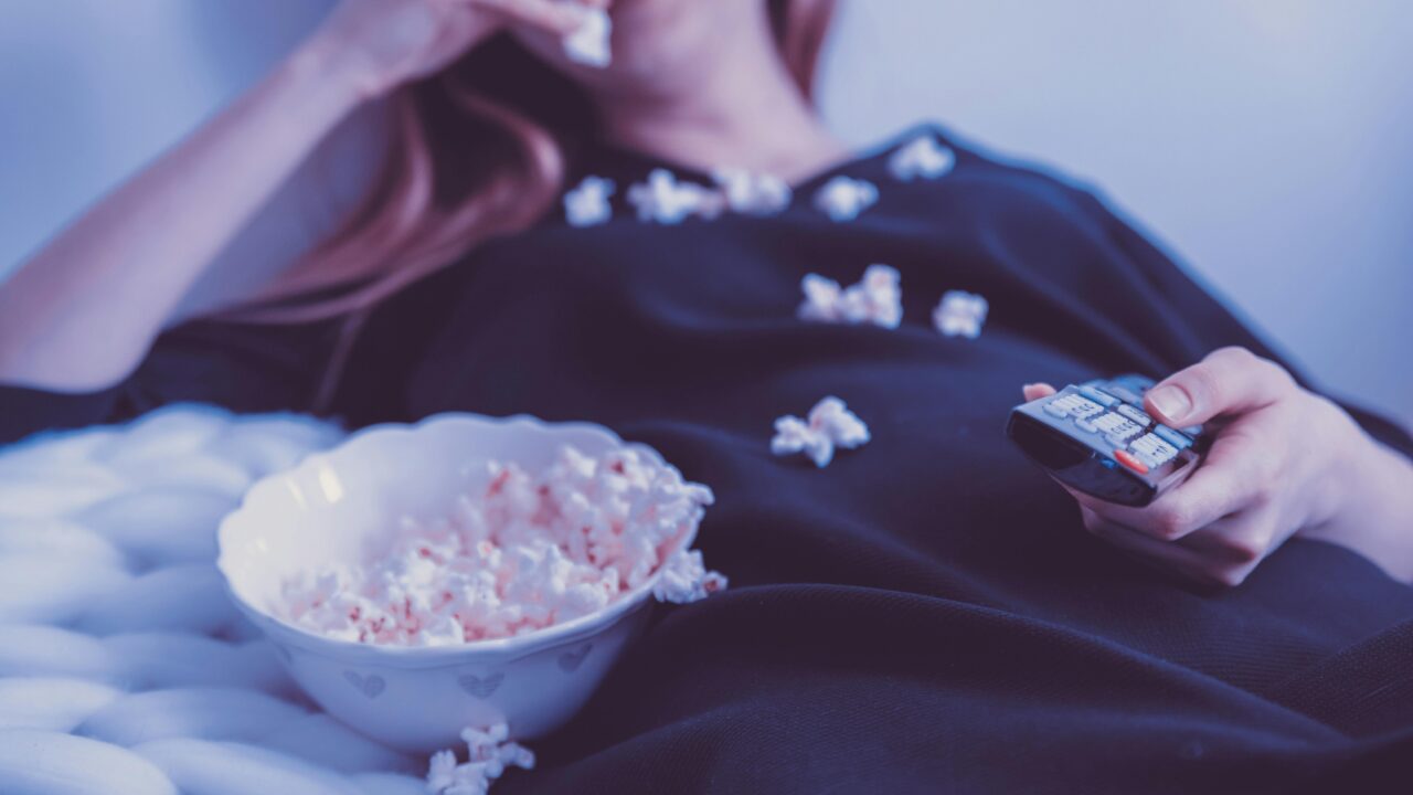 Woman Wearing Black Dress Shirt Eating Popcorn