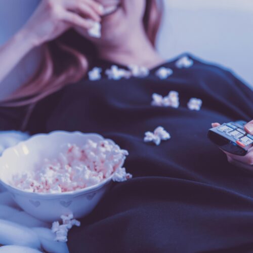 Woman Wearing Black Dress Shirt Eating Popcorn