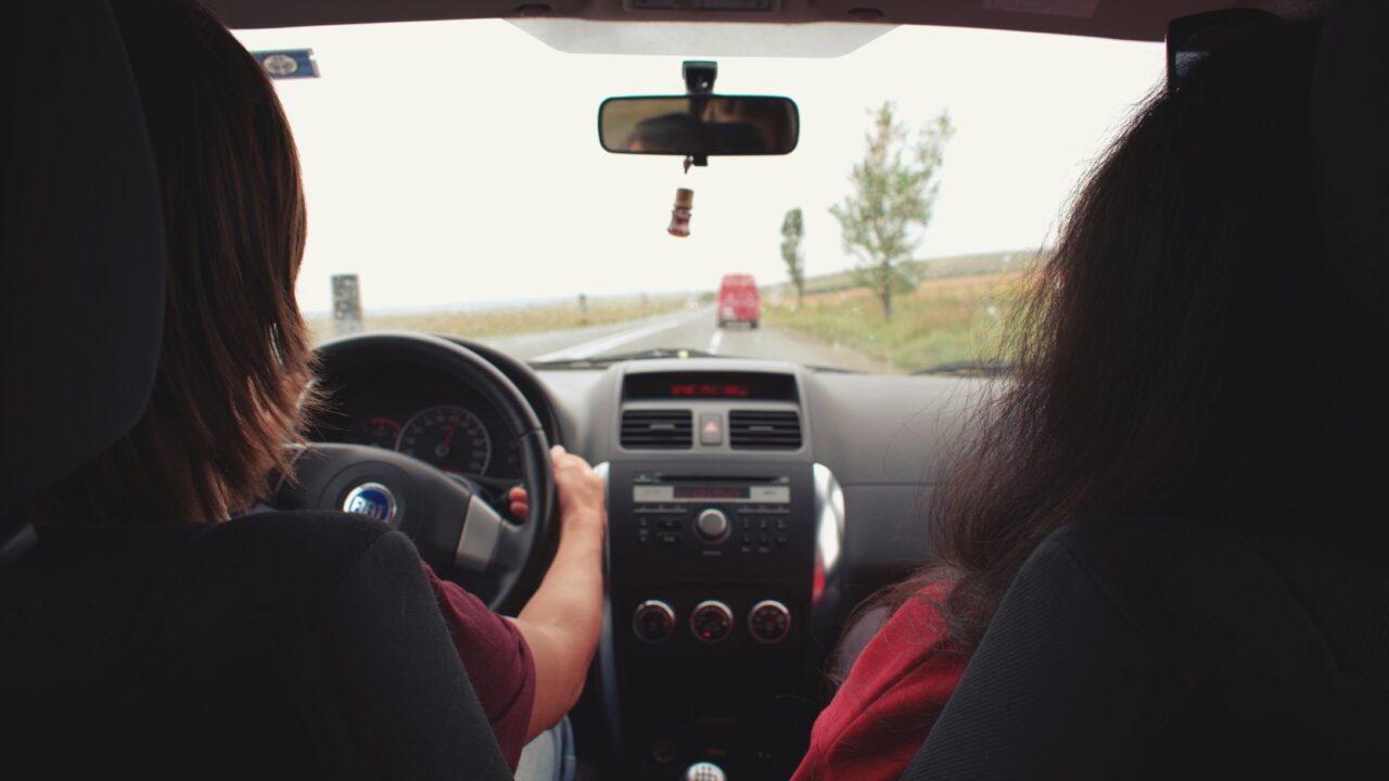 Two Woman Sitting Inside Vehicle