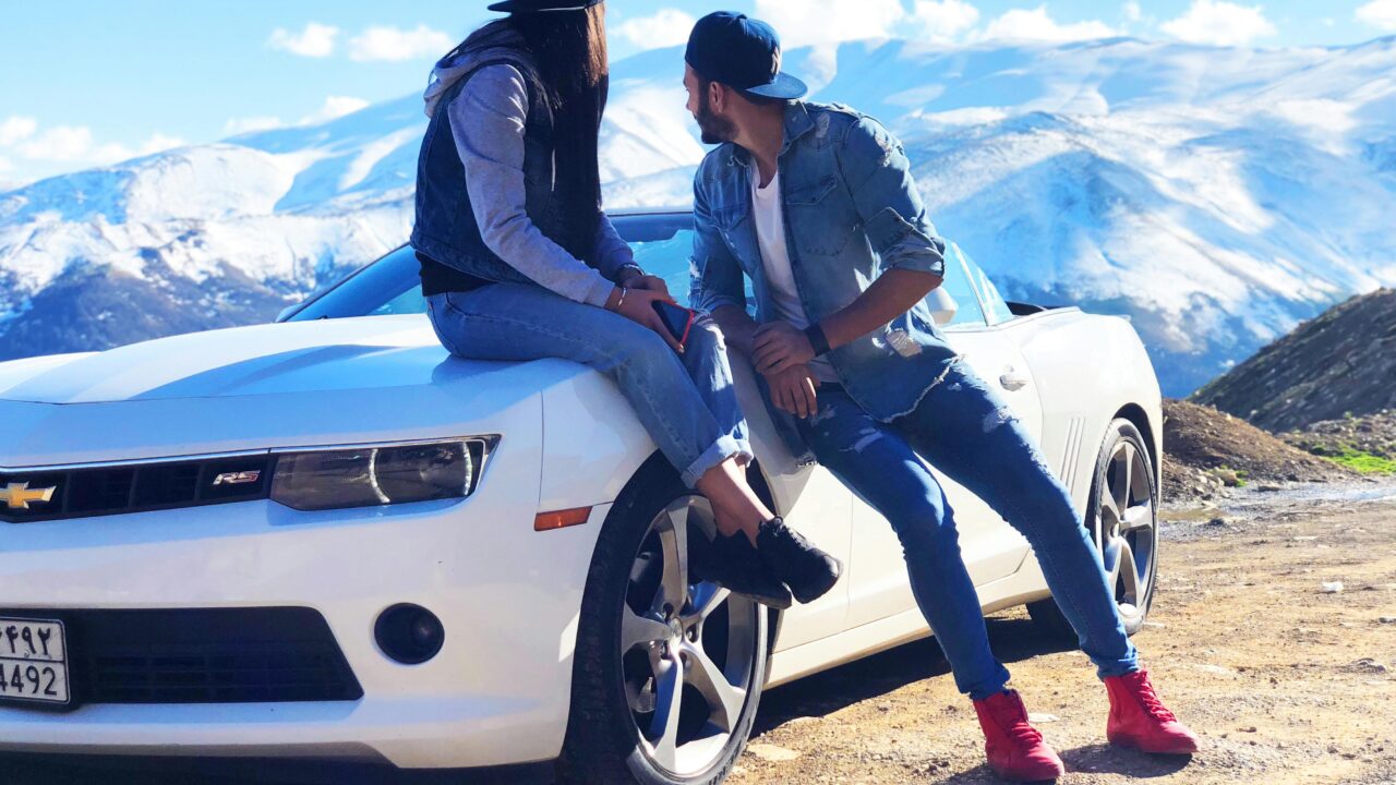 Couple Near White Chevrolet Coupe