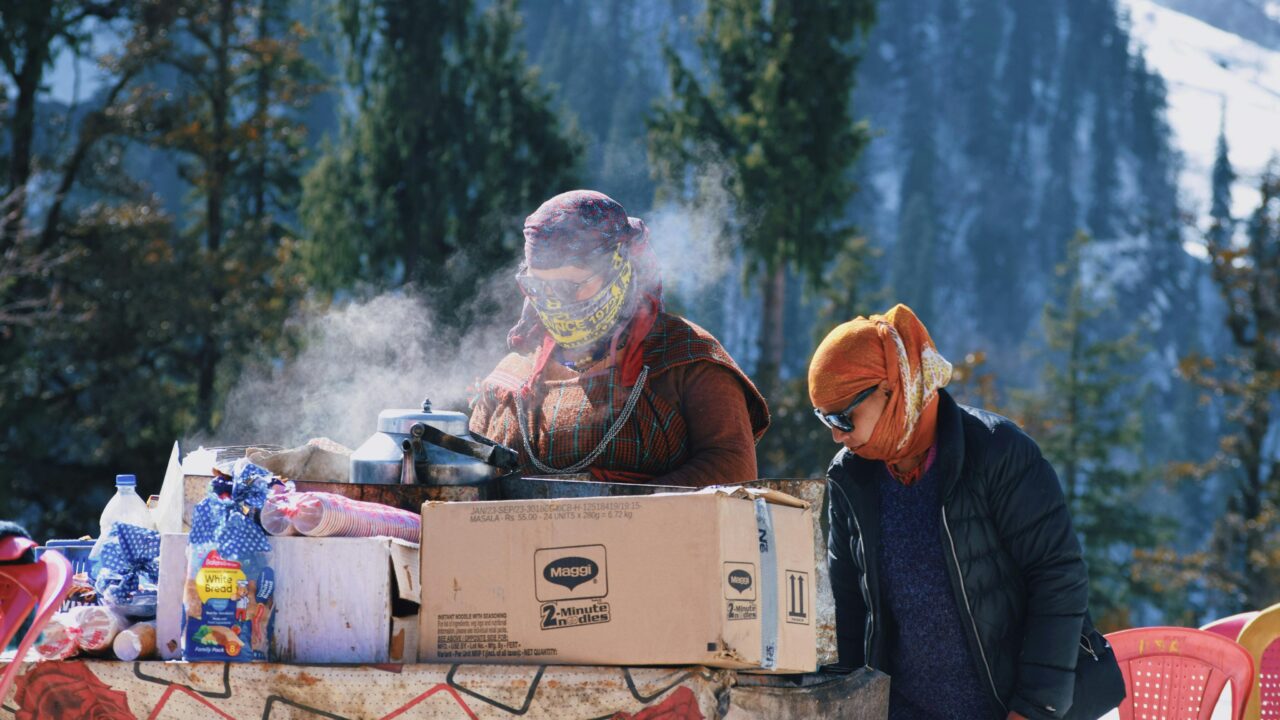 Women Making Food Outside in Winter in a Mountain Valley