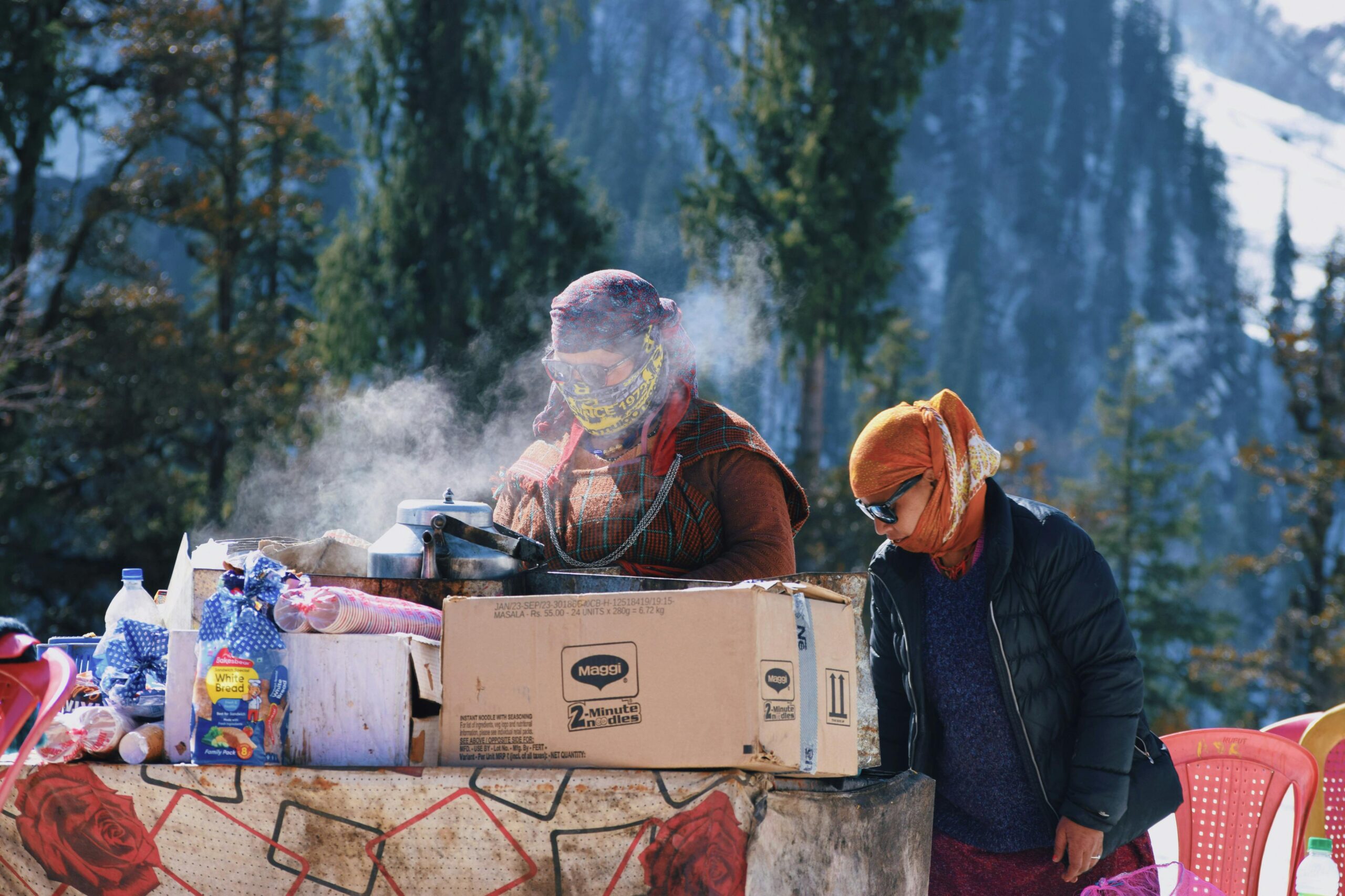 Women Making Food Outside in Winter in a Mountain Valley