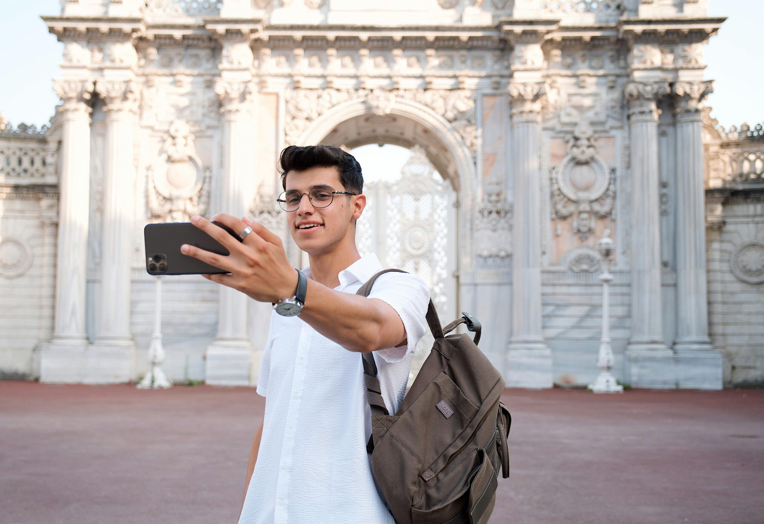 Young Man Taking a Selfie in front of the Dolmabahce Palace in Istanbul, Turkey