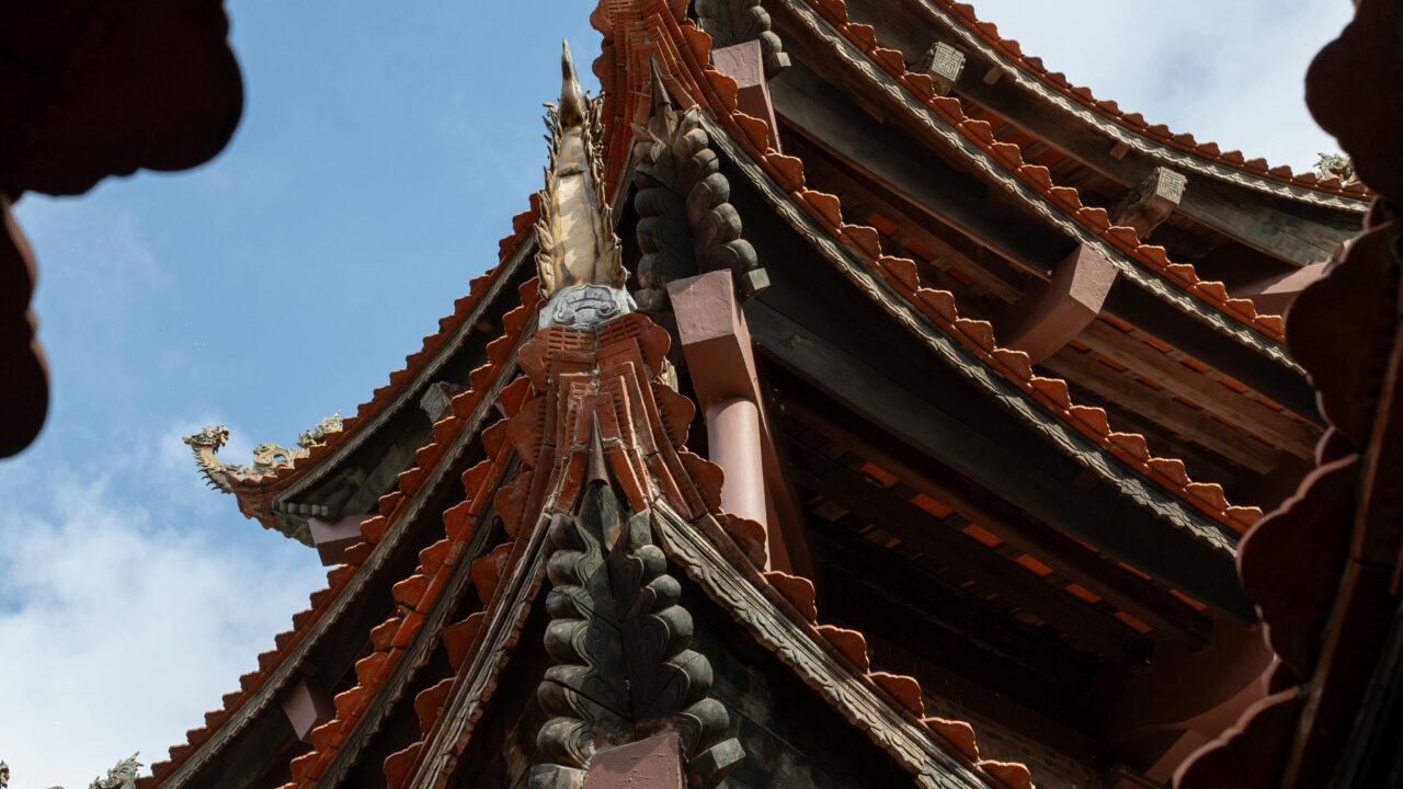 The roof of a chinese building with a blue sky