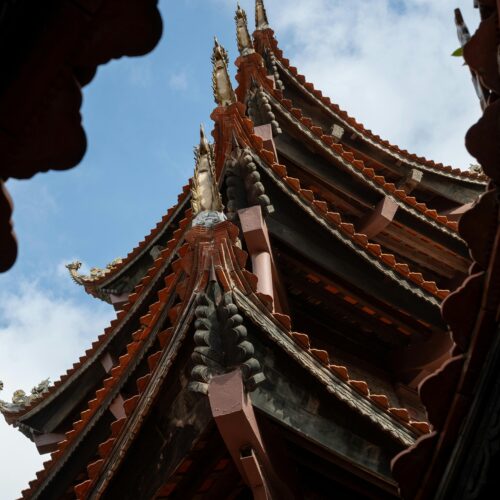 The roof of a chinese building with a blue sky