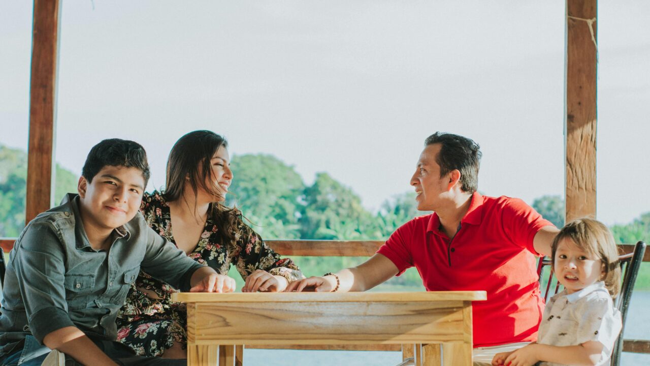 Happy family enjoying outdoor dining at lakeside