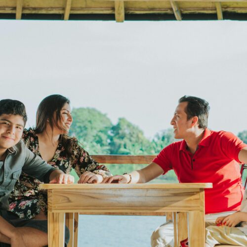 Happy family enjoying outdoor dining at lakeside