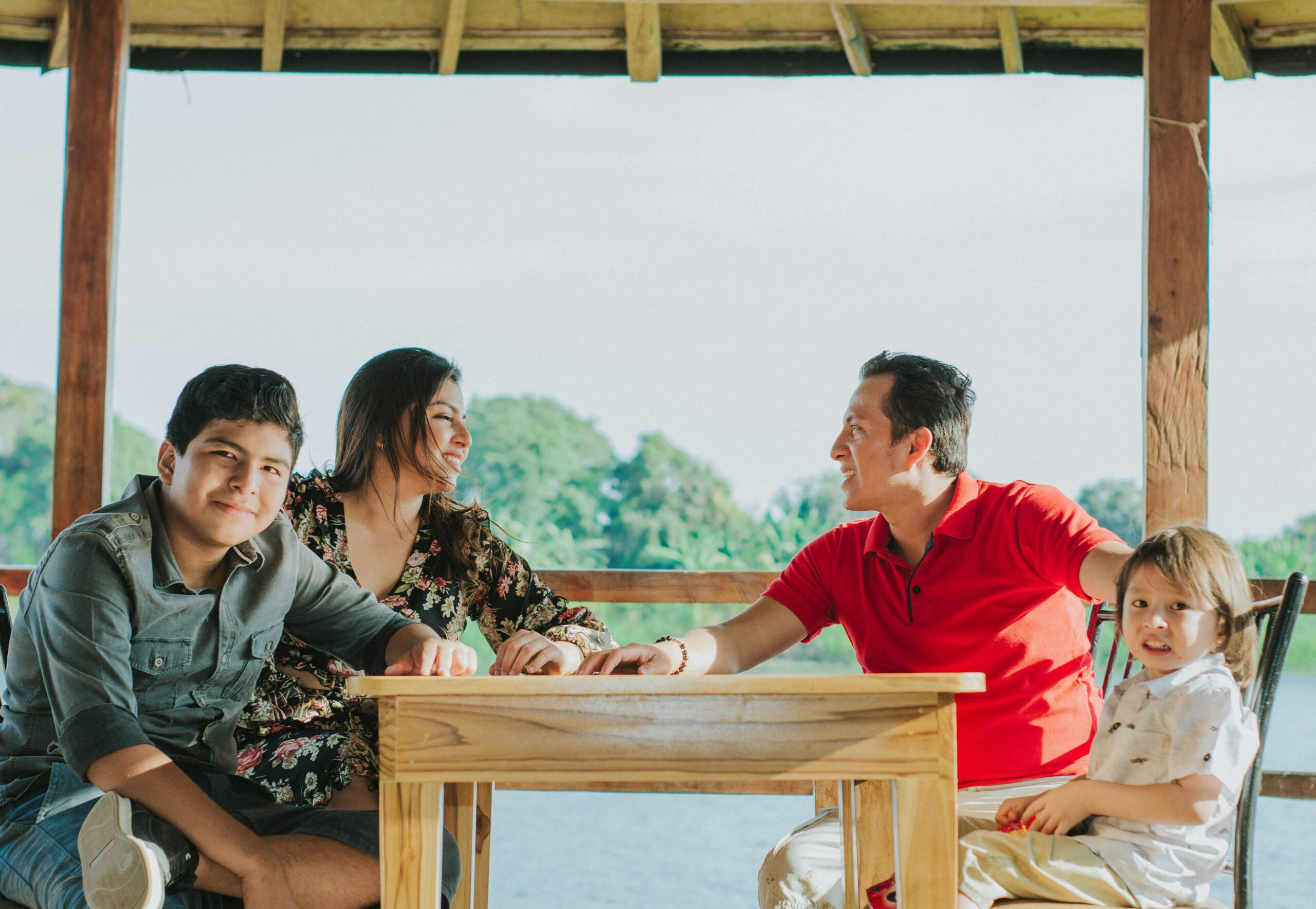 Happy family enjoying outdoor dining at lakeside