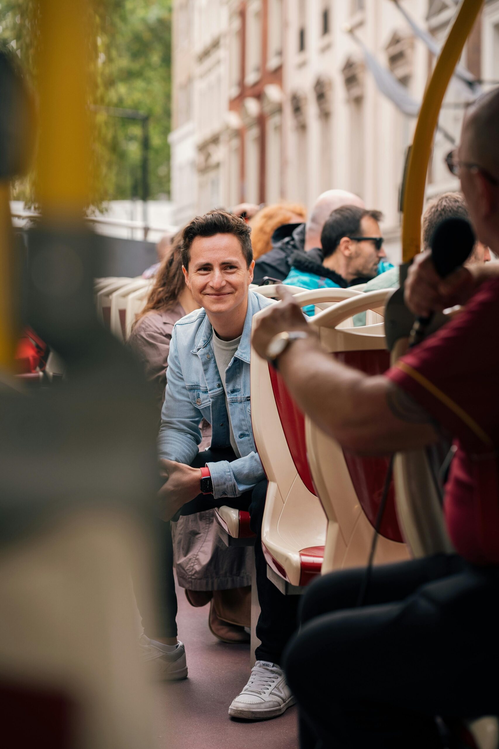 Smiling Man on Open-Top Bus Tour