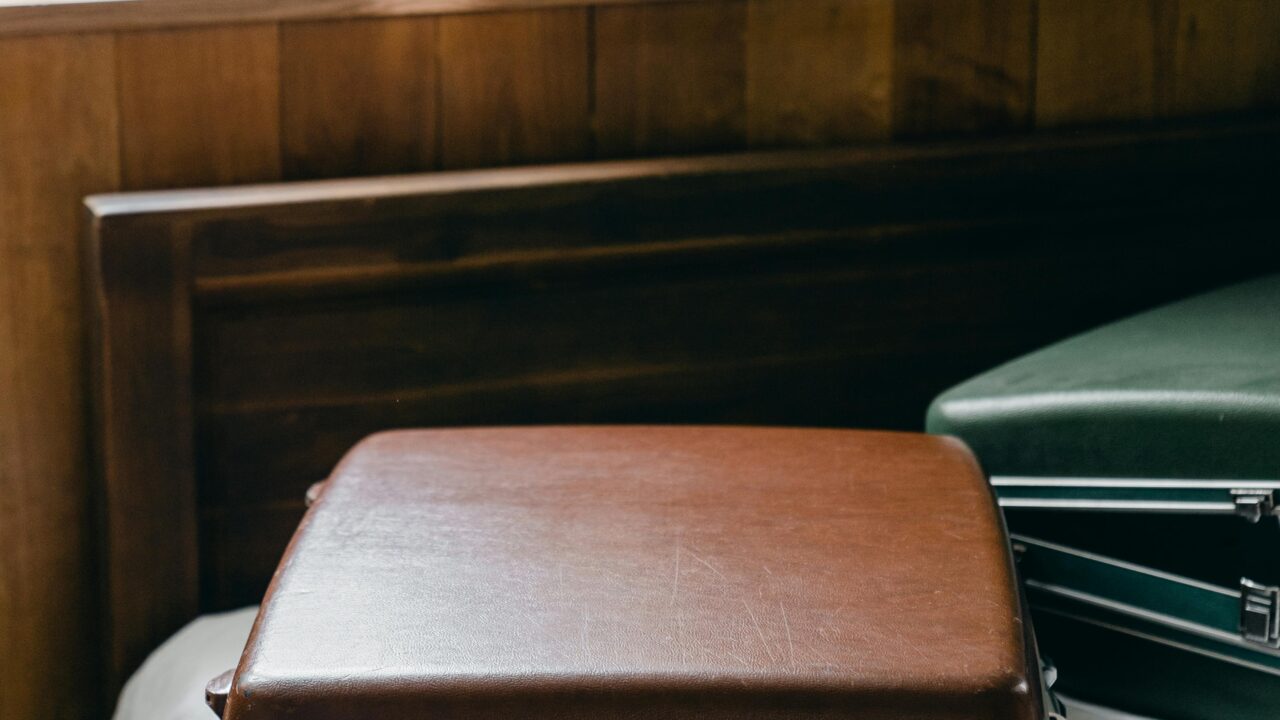 Suitcases placed on edge of bed