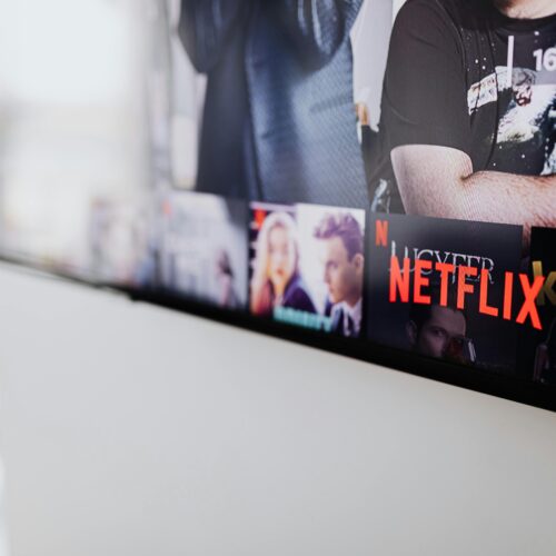 Black Flat Screen Tv Turned on Showing Man in Black Shirt