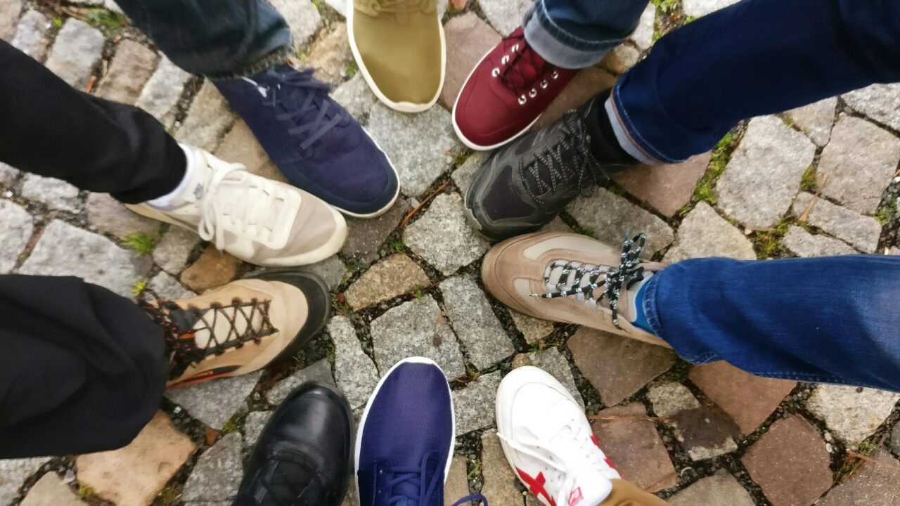 People Forming Round by Shoes