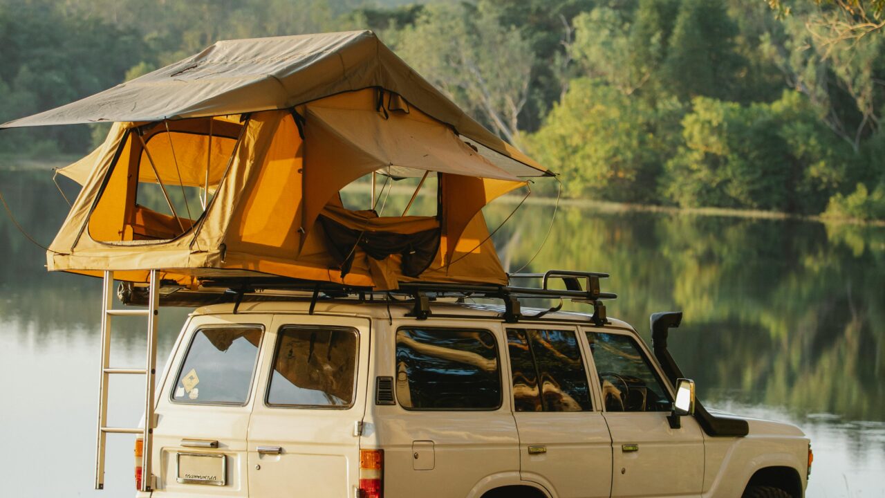 Tent on roof of car on lakeside