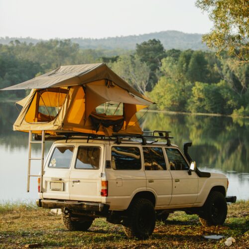 Tent on roof of car on lakeside