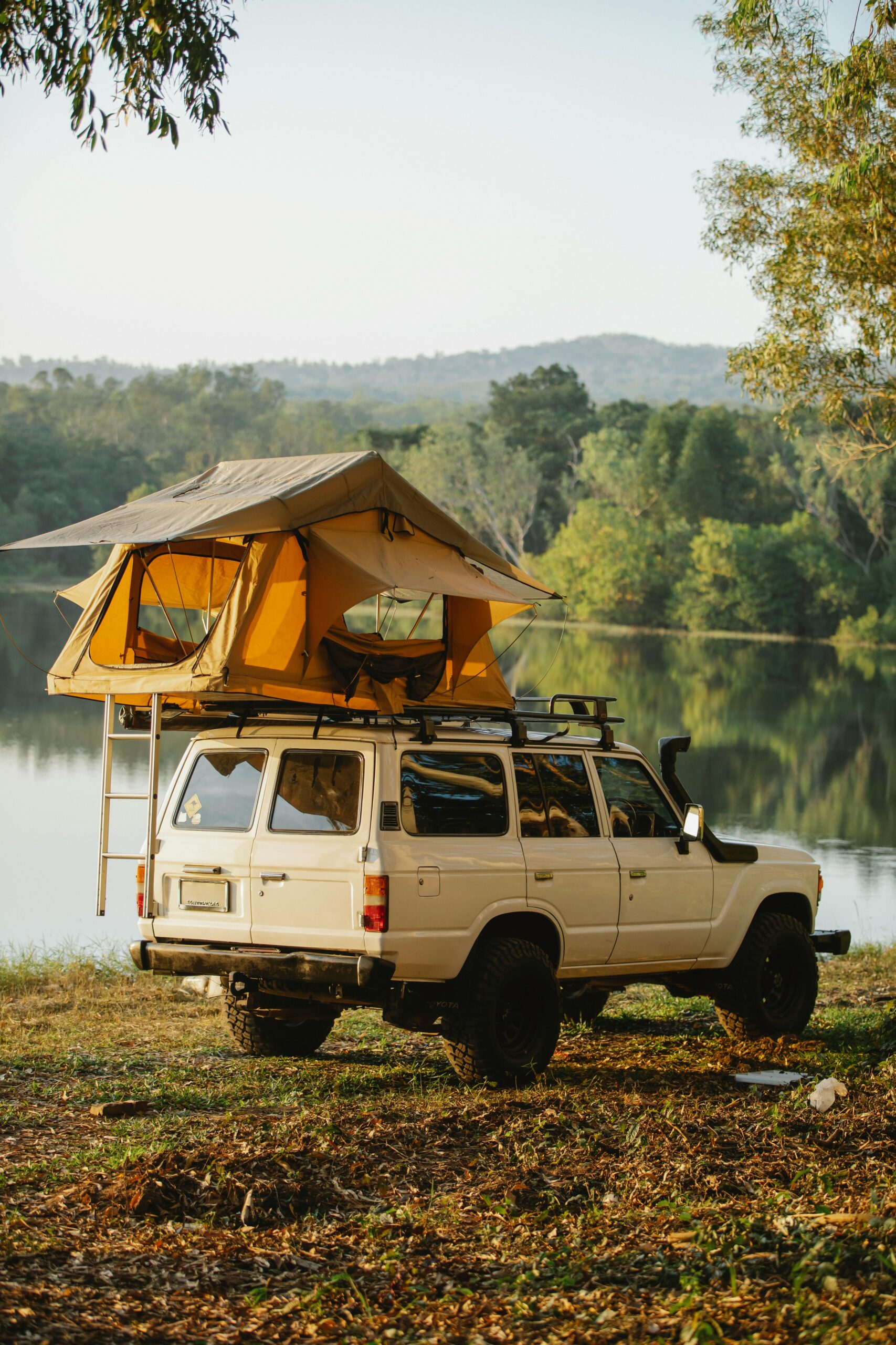 Tent on roof of car on lakeside