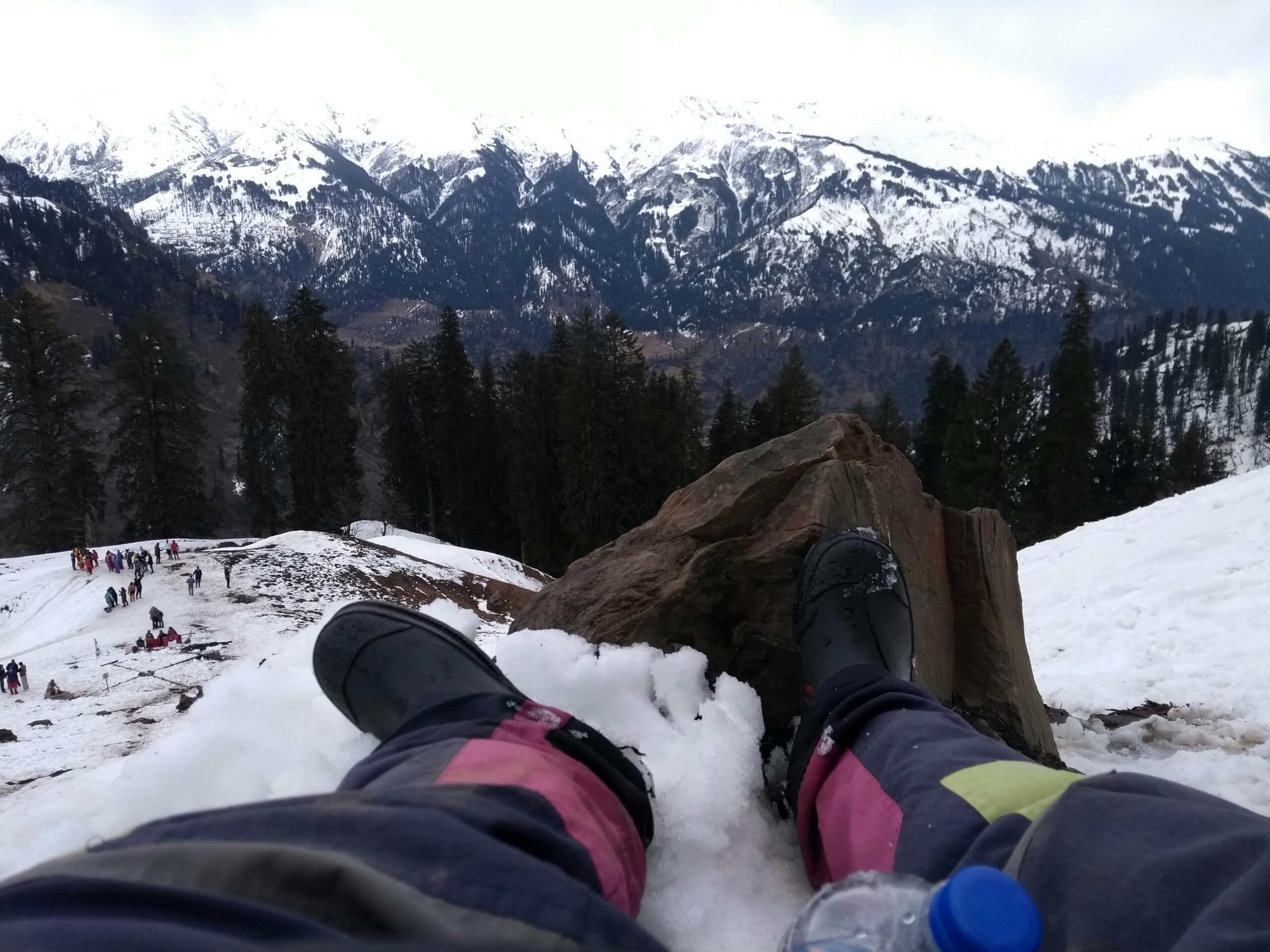 Person Wearing Black Boots At Snowy Mountain