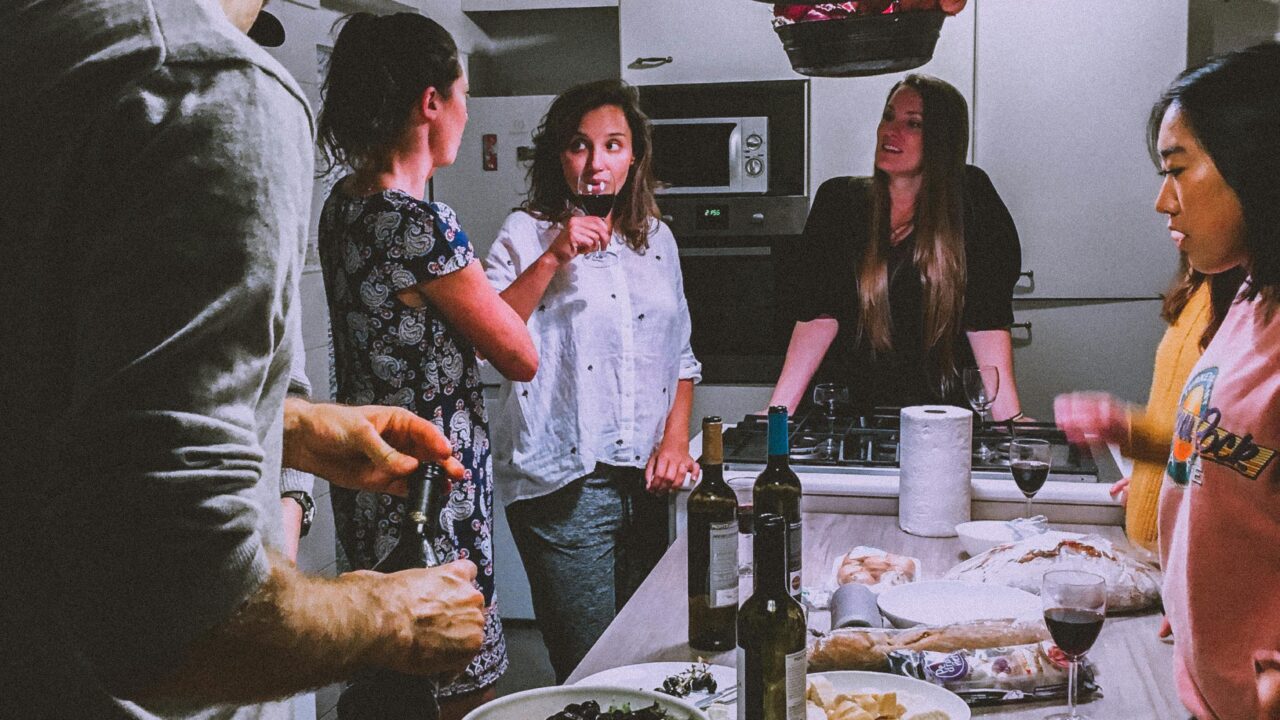 Men and Women Standing Infront of Dining Table