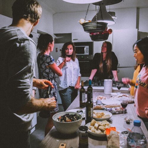 Men and Women Standing Infront of Dining Table