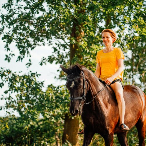 Photo of Woman Riding Horse Near Tree