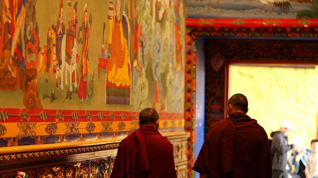 Monks Walking in Vibrant Tibetan Monastery