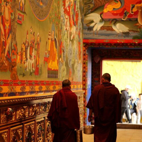 Monks Walking in Vibrant Tibetan Monastery