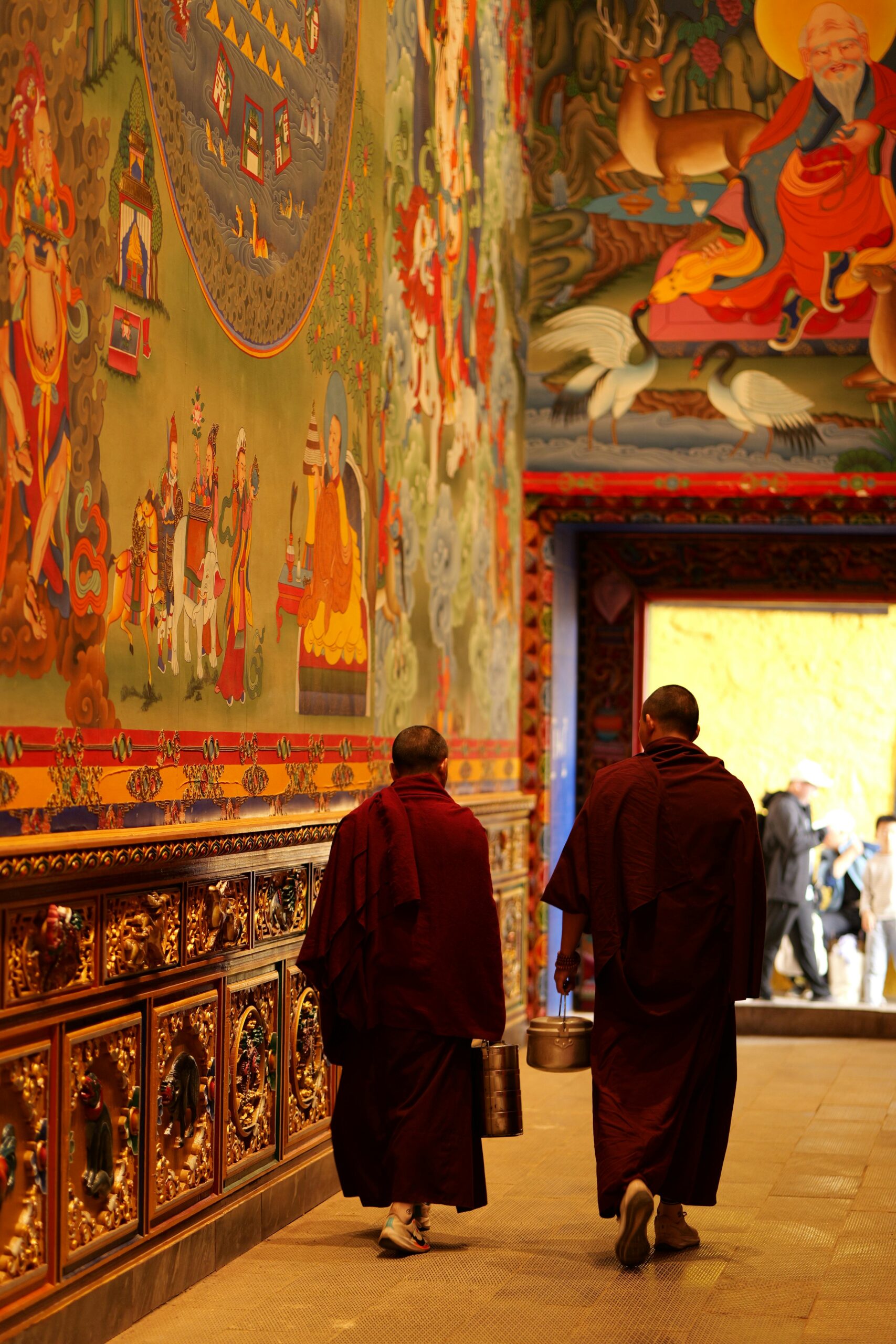 Monks Walking in Vibrant Tibetan Monastery