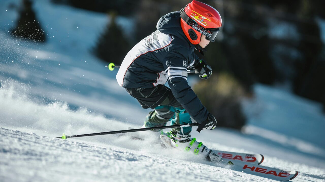 Man Doing Ice Skiing on Snow Field in Shallow Focus Photography