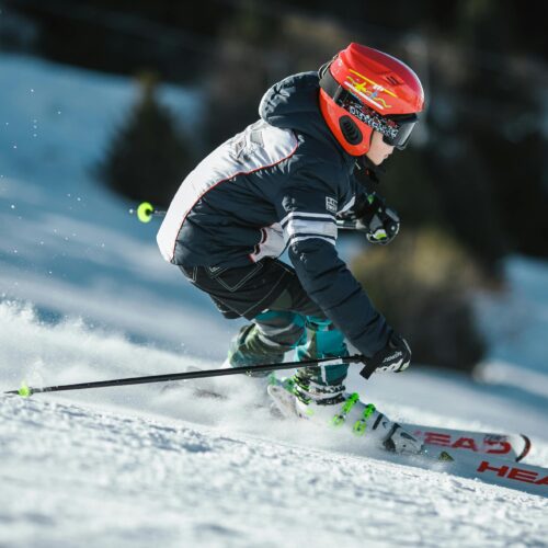 Man Doing Ice Skiing on Snow Field in Shallow Focus Photography